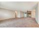 Large living room with neutral carpet and paint, featuring a cozy brick fireplace and access to other rooms at 110 Jackson Rd, Ladson, SC 29456