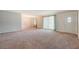 Bright living room with neutral carpet, large windows, and a modern chandelier at 110 Jackson Rd, Ladson, SC 29456