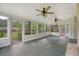 The sunroom has many windows, multiple ceiling fans, and access to the backyard at 110 Jackson Rd, Ladson, SC 29456