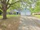 Charming single-story home featuring a two-car garage, brick accents, and mature trees in a suburban setting at 113 Saxton Ct, Goose Creek, SC 29445