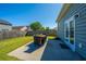 Grassy backyard featuring a patio, lawn, a view of the neighbor's house and a wooden fence at 1146 Moss Grove Dr, Moncks Corner, SC 29461