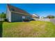 Backyard with a lawn and patio featuring a table with chairs, providing a spacious outdoor area at 1146 Moss Grove Dr, Moncks Corner, SC 29461