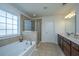Bathroom featuring a soaking tub, glass enclosed tiled shower, and double vanity at 1146 Moss Grove Dr, Moncks Corner, SC 29461