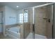 Bathroom featuring a soaking tub, glass shower stall, and natural light from the window at 1146 Moss Grove Dr, Moncks Corner, SC 29461