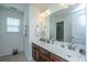 Bright bathroom featuring a double sink vanity with stylish fixtures and a large mirror at 1146 Moss Grove Dr, Moncks Corner, SC 29461