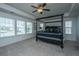 Bright bedroom featuring a four-poster bed, ceiling fan, and large windows at 1146 Moss Grove Dr, Moncks Corner, SC 29461