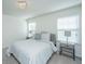 Cozy bedroom with a studded headboard bed frame and natural light from two windows at 1146 Moss Grove Dr, Moncks Corner, SC 29461