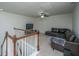 Upstairs loft area with soft carpeting, ceiling fan and a comfy couch at 1146 Moss Grove Dr, Moncks Corner, SC 29461