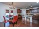 Eat-in kitchen and dining area boasting dark wood floors, modern lighting, and outside access through french doors at 1146 Moss Grove Dr, Moncks Corner, SC 29461