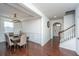 Elegant dining room featuring wainscoting, hardwood floors, chandelier and staircase to the second floor at 1146 Moss Grove Dr, Moncks Corner, SC 29461