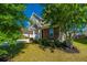 Two-story home with brick and siding exterior, features manicured landscaping and mature trees in front yard at 1146 Moss Grove Dr, Moncks Corner, SC 29461