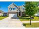 Charming two-story home with brick and siding, a well-manicured lawn, and an attached two-car garage at 1146 Moss Grove Dr, Moncks Corner, SC 29461