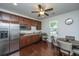 Spacious kitchen with stainless steel appliances and dark wood cabinetry with adjacent dining area at 1146 Moss Grove Dr, Moncks Corner, SC 29461