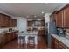 Beautiful kitchen with dark cabinets, stainless appliances, granite countertops, and seating at the island at 1146 Moss Grove Dr, Moncks Corner, SC 29461