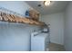 Efficient laundry room with full sized washer and dryer and wire shelving for storage at 1146 Moss Grove Dr, Moncks Corner, SC 29461