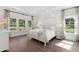 Bright bedroom with a four-poster bed, natural light, wood floors, and tranquil views of nature at 1149 Darling St, Summerville, SC 29485