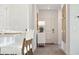 Hallway view of a neutral color palette and decorative wallpaper leading to the front door and dining area at 1149 Darling St, Summerville, SC 29485