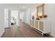 Hallway featuring wood-look flooring, white walls, console table, and ornate mirror decor at 1149 Darling St, Summerville, SC 29485
