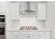 Kitchen featuring gas cooktop, white cabinetry, stainless steel range hood, and quartz countertops at 1149 Darling St, Summerville, SC 29485