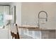 Close-up of kitchen bar featuring barstools, modern faucet, and decorative wallpaper at 1149 Darling St, Summerville, SC 29485