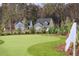 Scenic putting green with manicured turf and flags nestled between elegant homes at 1149 Darling St, Summerville, SC 29485