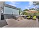 Backyard deck with hot tub, umbrella, and outdoor lounge chairs at 116 Backhurst Dr, Summerville, SC 29486