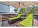 Backyard deck with hot tub and outdoor lounge chairs under a large umbrella at 116 Backhurst Dr, Summerville, SC 29486
