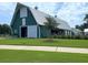 Green barn-style clubhouse and white trim with open door and large lawn at 116 Backhurst Dr, Summerville, SC 29486