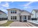 The back of this two-story home includes a screened-in porch and a hot tub at 116 Backhurst Dr, Summerville, SC 29486