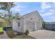 Side-view of detached garage reveals private entry door and professional landscaping at 116 Backhurst Dr, Summerville, SC 29486