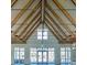 Spacious room featuring a soaring ceiling with exposed wooden beams and an abundance of natural light from large windows at 116 Backhurst Dr, Summerville, SC 29486