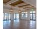 Elegant gathering room featuring tray ceilings, stylish light fixtures, and expansive windows at 116 Backhurst Dr, Summerville, SC 29486