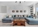 Comfortable living room featuring a sectional sofa with throw pillows, a wood coffee table, and wall paneling at 116 Backhurst Dr, Summerville, SC 29486