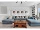 Inviting living room with a large sectional sofa, a wood coffee table, and stylish wall paneling at 116 Backhurst Dr, Summerville, SC 29486