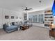 Spacious living room with a large sectional sofa, a wood coffee table, and custom built-in bookshelves at 116 Backhurst Dr, Summerville, SC 29486