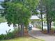 Scenic walking path leads to the pond's covered wooden dock on a clear day at 116 Backhurst Dr, Summerville, SC 29486