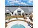 Aerial view of a community pool and amenity center surrounded by palm trees, sidewalks and lush landscaping at 116 Backhurst Dr, Summerville, SC 29486