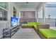 Relaxing screened porch featuring an outdoor television and comfortable wicker furniture at 116 Backhurst Dr, Summerville, SC 29486