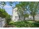 Backyard featuring a white fence, mature trees, lush green grass, and an outdoor patio set at 117 Blue Bonnet St, Summerville, SC 29483
