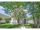 Backyard featuring lush green grass, mature trees, a white fence, and an outdoor patio set at 117 Blue Bonnet St, Summerville, SC 29483