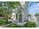 Backyard featuring lush green grass, mature trees, a white fence, a patio, and well maintained landscaping at 117 Blue Bonnet St, Summerville, SC 29483