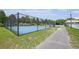 Community basketball court with green lawn, walking path, and manicured shrubbery at 117 Blue Bonnet St, Summerville, SC 29483