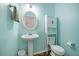 Powder room with pedestal sink, toilet, and modern wall cabinet at 117 Blue Bonnet St, Summerville, SC 29483