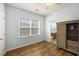 Bright bedroom showcasing a large window, wood floors, and a view into ensuite bathroom at 117 Blue Bonnet St, Summerville, SC 29483