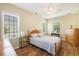 Sunlit bedroom with wood floors, ceiling fan, and natural light from two windows at 117 Blue Bonnet St, Summerville, SC 29483