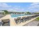 Large rectangular community pool lined with lounge chairs, green lawn, and community center at 117 Blue Bonnet St, Summerville, SC 29483
