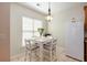 Bright dining area featuring a modern light fixture, tile floors, and a cozy window at 117 Blue Bonnet St, Summerville, SC 29483