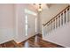 Inviting entryway featuring stylish wood floors, and a staircase with white spindles and wooden handrail at 117 Blue Bonnet St, Summerville, SC 29483