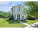 Charming two-story home featuring a quaint balcony, manicured lawn, and inviting front entrance at 117 Blue Bonnet St, Summerville, SC 29483
