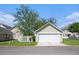 Exterior view of the detached garage with a white door, white fence, and manicured lawn at 117 Blue Bonnet St, Summerville, SC 29483